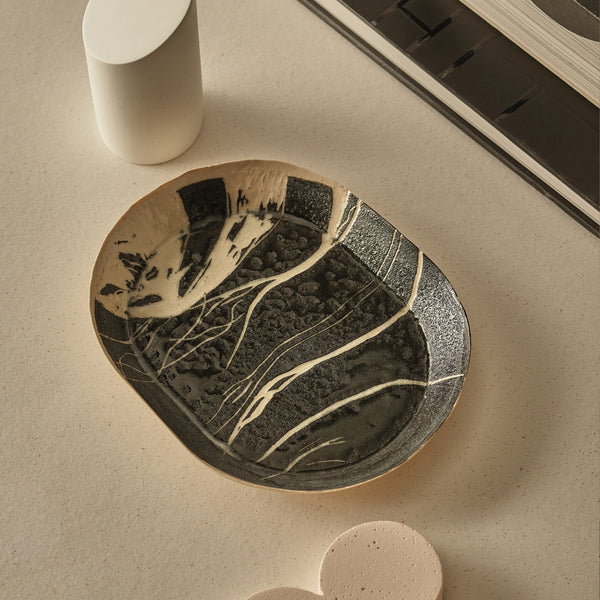 Ceramic plate with artistic design on a beige surface