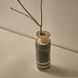 Decorative vase with a branch on a beige background